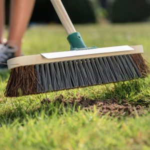 westland lawn seeding soil in use brushing in hand